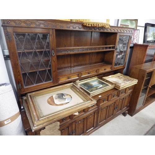 2435 - An oak dresser with lead and glazed panels and multiple drawers