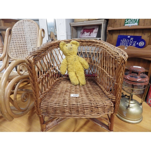 2297 - A 1930's wicker child's chair and bear