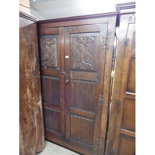 2362 - A carved oak wardrobe