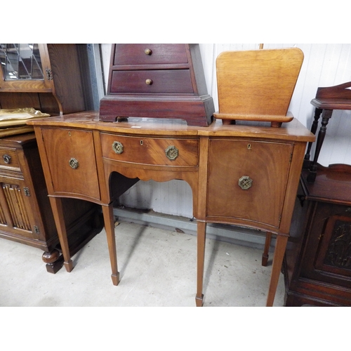 2439 - A Georgian style mahogany serpentine sideboard