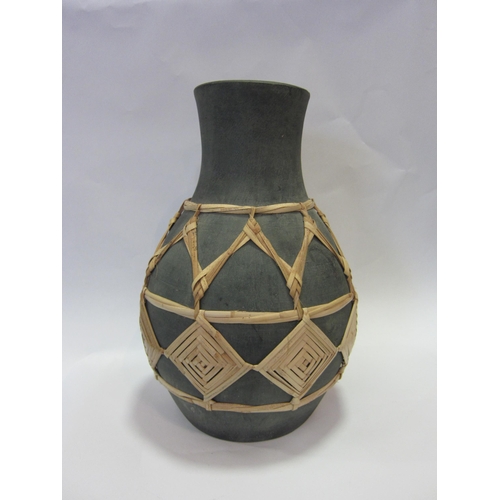 1201 - A vase with geometric dried grass decoration, 42.5cm