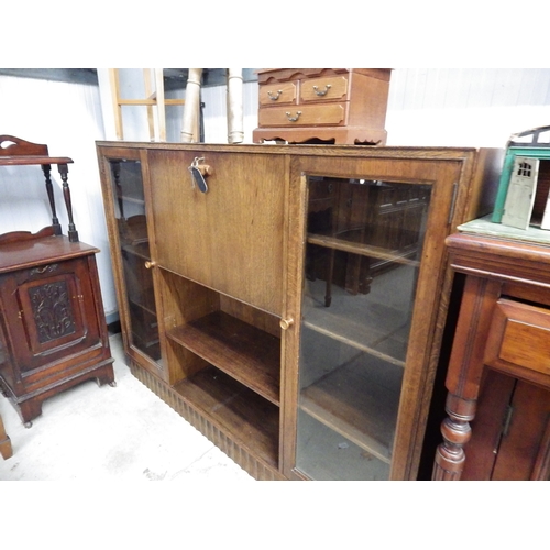 2444 - An oak side unit with bevelled edged glass doors and a shelved interior   (E) £8-12