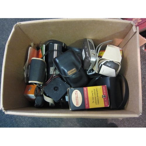 1232 - A box of cameras to include Canon T70 SLR