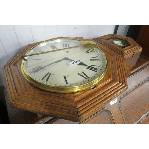 2125 - An oak cased wall clock with key and pendulum