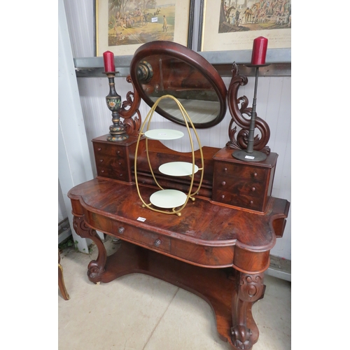 2168 - A Victorian mahogany dressing table on carved front legs with drawers beneath oval mirror together w... 