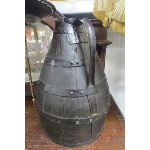 2229 - A large copper jug and an oak metal bound flagon