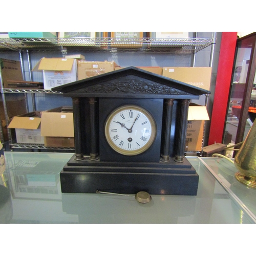 1447 - A late 19th Century black slate mantel clock, white enamel dial with Roman numerals