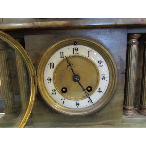 1451 - An onyx 8-day mantel clock, numerated chapter ring, key and pendulum