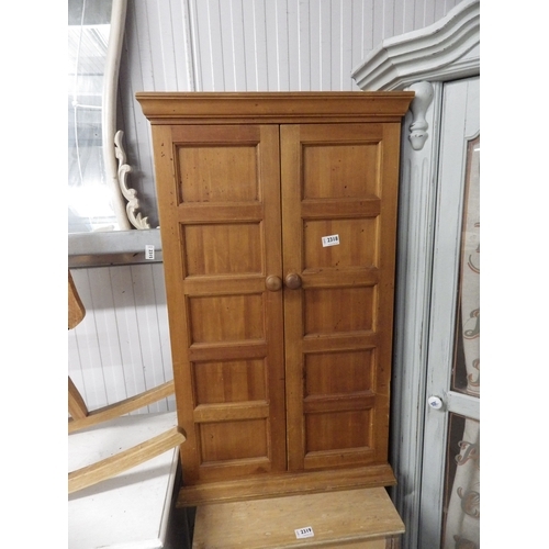 2318 - A two door pine cupboard with a shelved interior   (E) £20-30