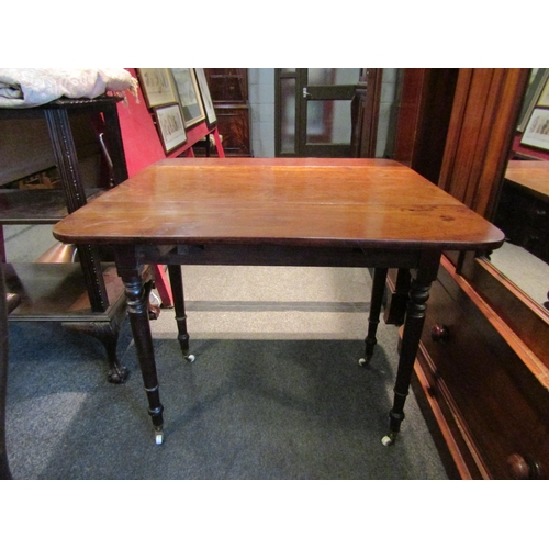 1137 - A 19th Century mahogany Sutherland table, two single drawers and two dummy drawers, raised on turned... 