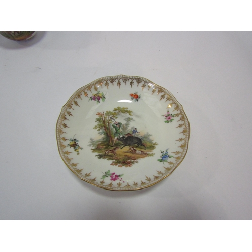 1345 - A Meissen cabinet cup and saucer, hand-painted with hunting scenes, gilt embellishment.  A monotone ... 