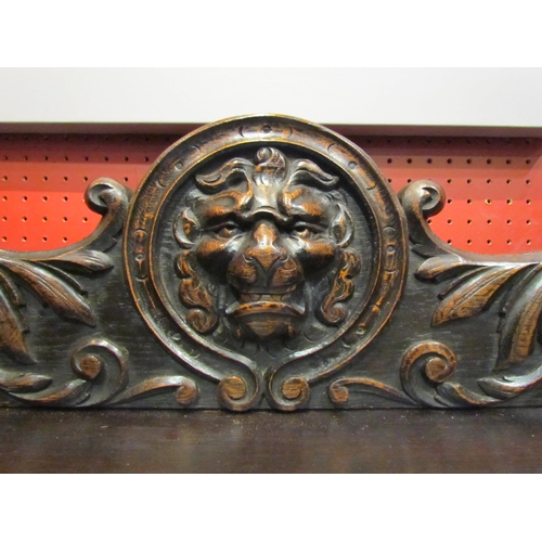 4062 - A late Victorian carved oak sideboard with lion's head and winged angel decoration, the two drawers ... 