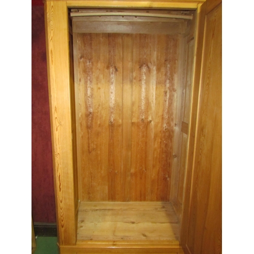 4163 - A 19th Century stripped pine French single door armoire with key and base drawer on turned feet and ... 