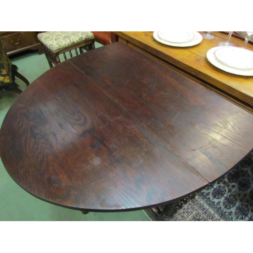 4193 - An Edwardian 17th Century revival oak oval top gate-leg table, the rising leaves over barley-twist l... 