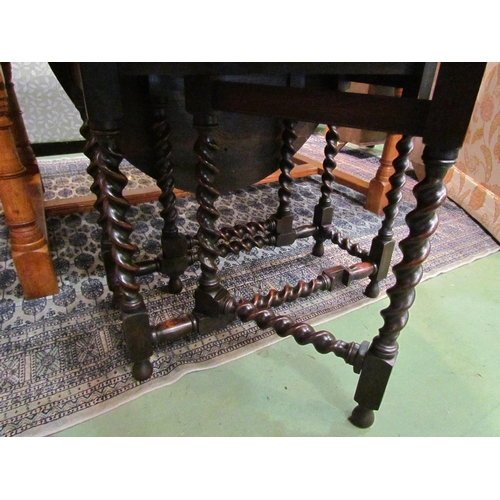 4193 - An Edwardian 17th Century revival oak oval top gate-leg table, the rising leaves over barley-twist l... 