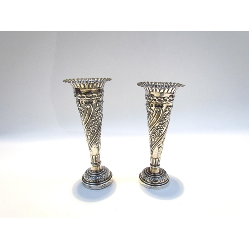 4366 - A near pair of silver embossed bud vases, 11g total