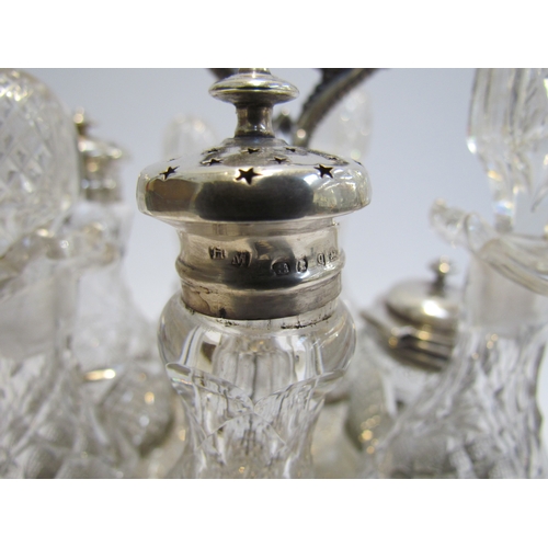 4387 - A Victorian silver plate cruet stand with swivel 7 bottle container, 3 with silver lids. Floral embo... 