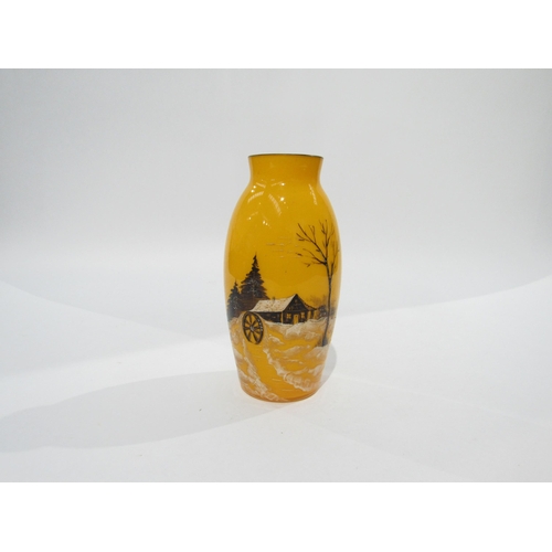 4478 - An orange glass vase depicting a silhouette of a log cabin, cartwheel and trees in a snowy landscape... 