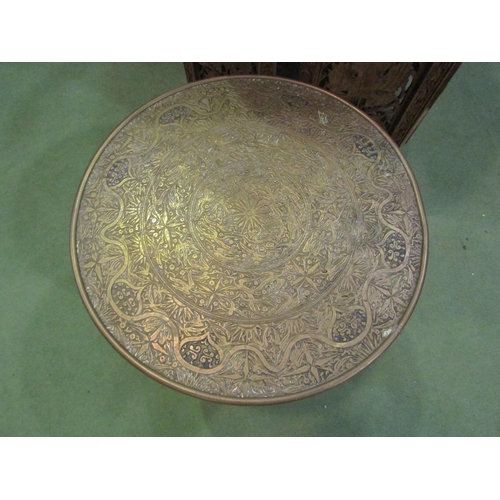 4009 - An Indian brass-top coffee table together with a repoussé charger and an Indian carved hardwood coff... 