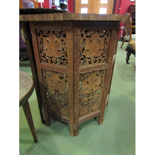 4009 - An Indian brass-top coffee table together with a repoussé charger and an Indian carved hardwood coff... 