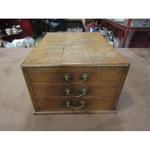 4012 - An early 20th Century oak three drawer cutlery canteen with contents