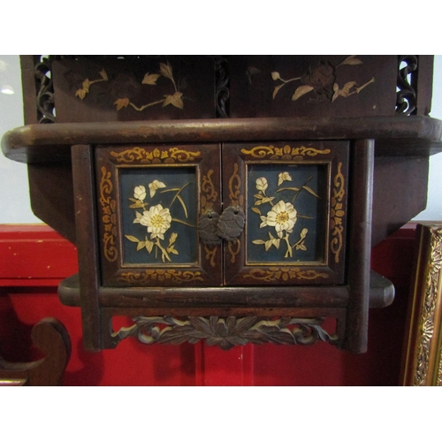 4024 - A Japanese wall hanging display shelf with floral design doors, fretwork friezes and enriched with g... 