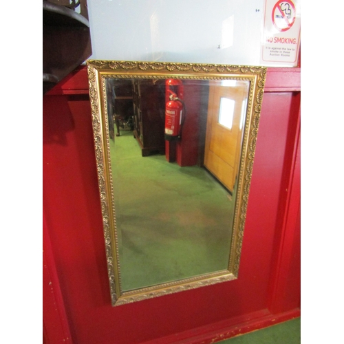 4026 - A gilt framed bevel edged wall mirror. Mirror plate 67.5cm x 39.5cm