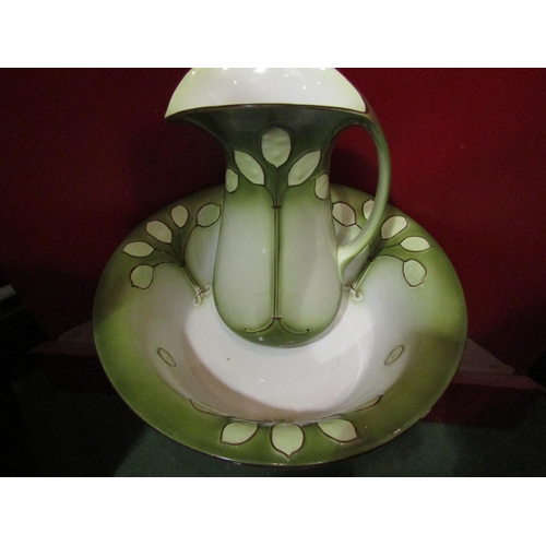 4053 - An Art Nouveau era wash jug and bowl, green tint with leaf design