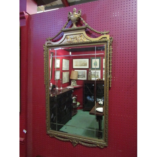 4073 - A Louis XVI style gilt framed wall mirror with urn and swag detail, 115cm x 61cm total