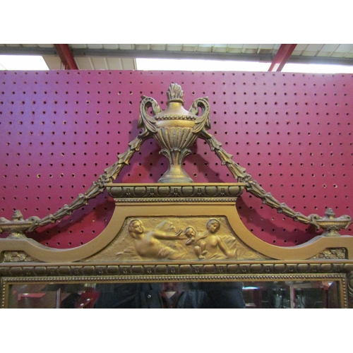 4073 - A Louis XVI style gilt framed wall mirror with urn and swag detail, 115cm x 61cm total