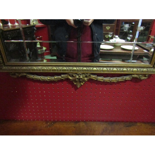 4073 - A Louis XVI style gilt framed wall mirror with urn and swag detail, 115cm x 61cm total