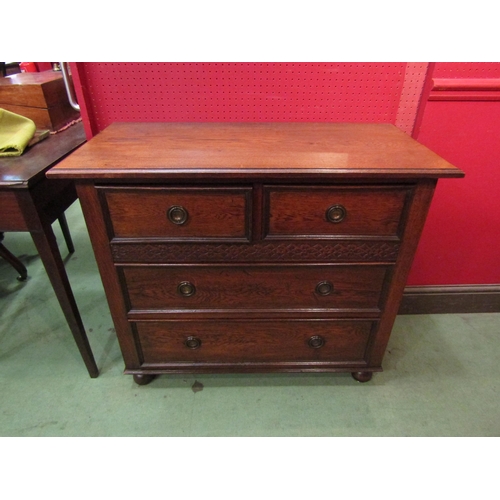 4095 - A circa 1920 oak chest of small proportions, the two short over two long drawers with blind fret dec... 