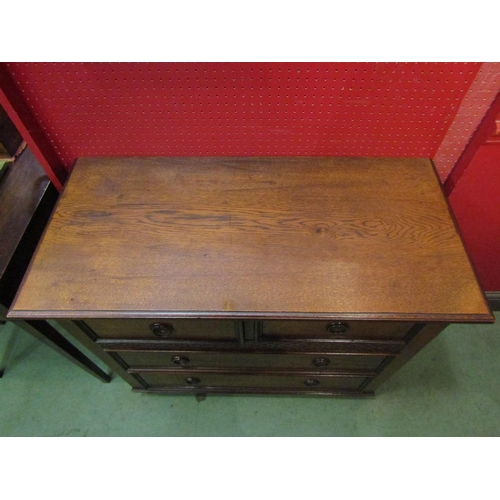 4095 - A circa 1920 oak chest of small proportions, the two short over two long drawers with blind fret dec... 