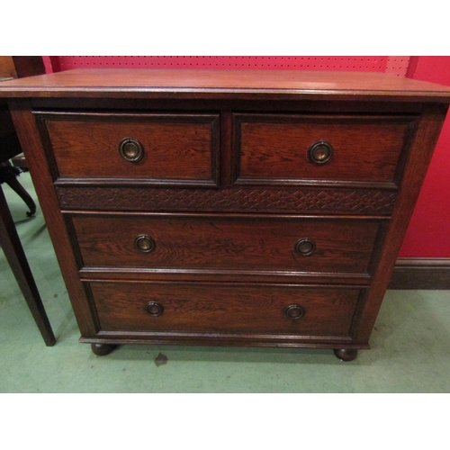 4095 - A circa 1920 oak chest of small proportions, the two short over two long drawers with blind fret dec... 