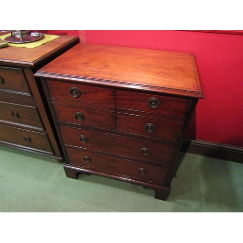 4096 - A George III crossbanded flame mahogany cabinet the two doors over two long drawers and bracket feet... 