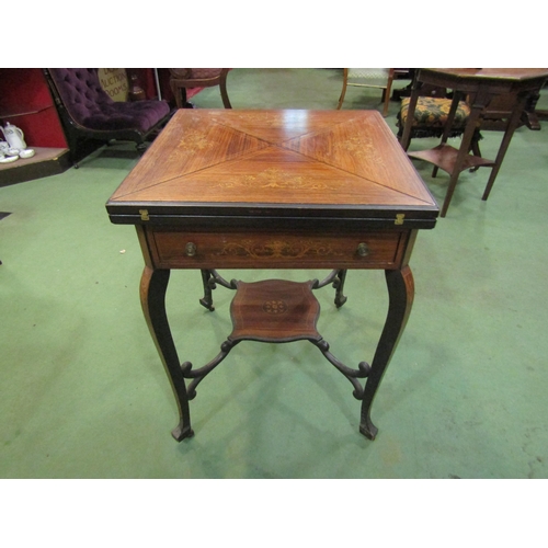 4119 - An Edwardian walnut marquetry inlaid envelope card table, the four-fold top over single frieze drawe... 