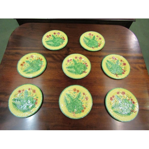 4125 - A set of eight Majolica style yellow and green glazed plates with leaf and floral pattern, 23.5cm di... 