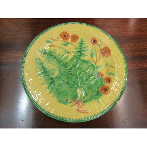 4125 - A set of eight Majolica style yellow and green glazed plates with leaf and floral pattern, 23.5cm di... 