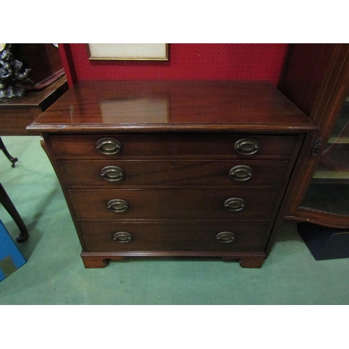 4133 - A Georgian flame mahogany chest of small proportions, the four graduating long drawers with oval bac... 