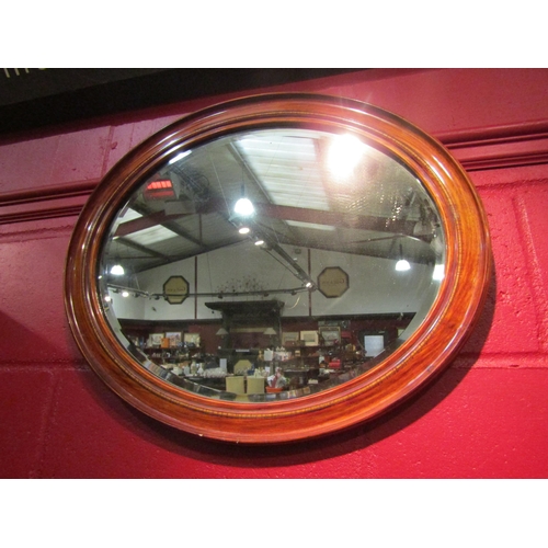 4157 - An inlaid bevel edged oval mirror, 59cm long