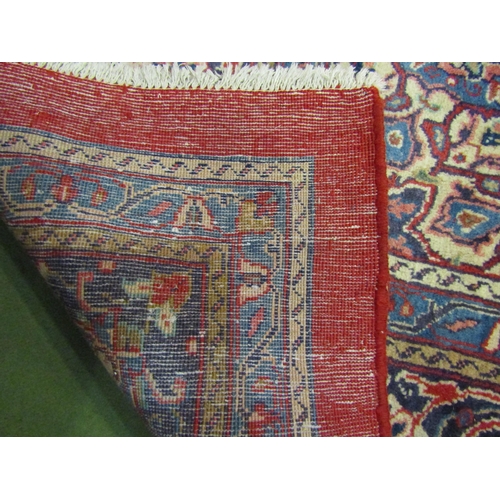 4504 - An Eastern wool rug, red ground central single medallion flanked by blue multiple borders, 400cm x 3... 