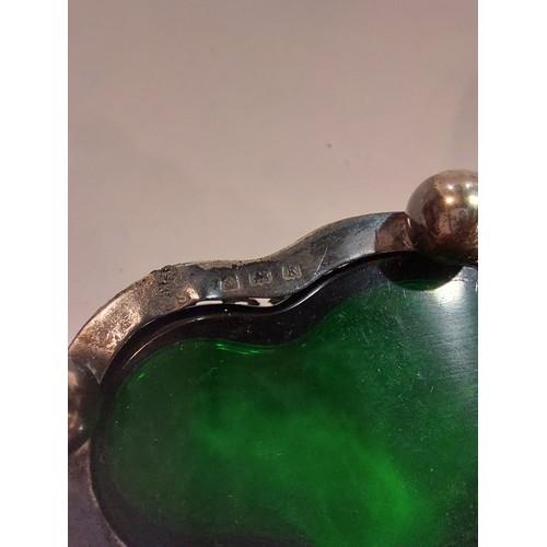 4381 - A pierced silver salt with green glass liner, sugar tongs and a Continental silver strainer (3)