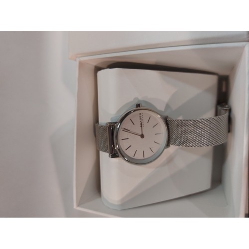 A Tissot manual wind gents watch Skagen ladies watch and a silver