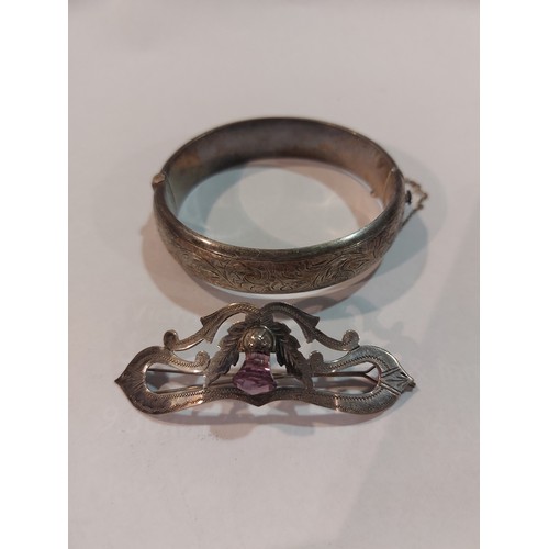 4398 - A silver foliate engraved bangle together with a silver hair clip with engraved thistle design set w... 