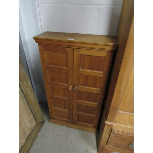 2224 - A two door pine cupboard with a shelved interior