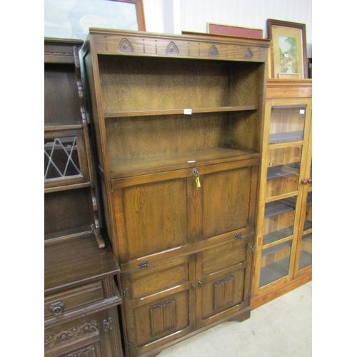 2296 - An Old Charm style oak full height cupboard with bookcase top