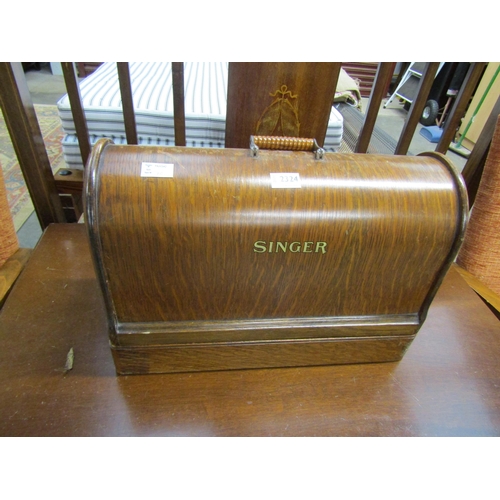 2324 - An oak cased Singer sewing machine