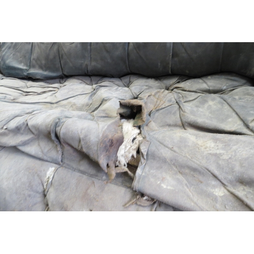 2001 - A Victorian well worn leather sofa on three turned front legs for restoration