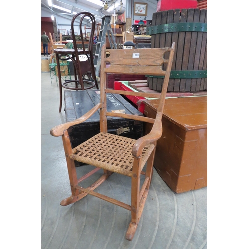 2011 - A 19th century provincial elm and rope seated rocking chair