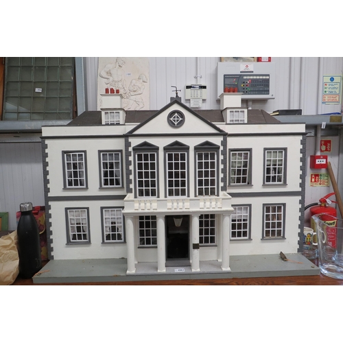 2062 - A Georgian style three story dolls house with some furniture contents